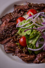 Filet mignon with tomatoes and salad