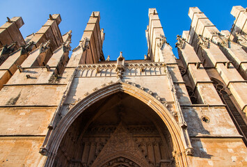 The facade of the cathedral on the island of Palma de Mallorca, viewed from below during the day.