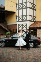 young couple bride and groom in a white short dress