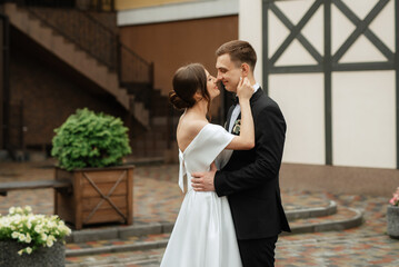 Fototapeta premium young couple bride and groom in a white short dress