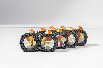 Black sushi roll with tuna and salmon