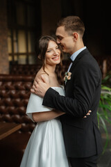 young couple bride and groom in a white short dress