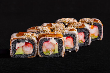 Rolls with black rice, eel, sesame seeds, cream cheese