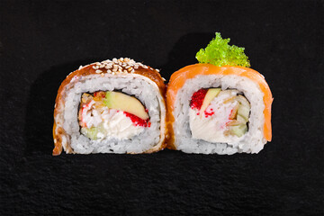 Roll with tobiko caviar, sesame seeds, salmon, eel, cucumber