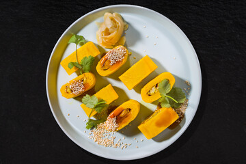 Plate with rolls with omelette, sesame seeds, ginger, parsley