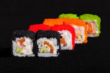 Rolls with rice, cream cheese, salmon, tobiko caviar