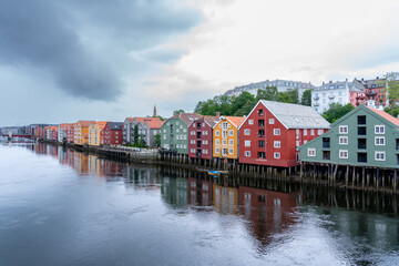 Trondheim, Norway  reflection of colorful houses on the river on an overcast day 