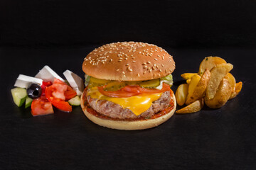 Hamburger with pork cutlet, cheese, tomato, cucumber, sauce