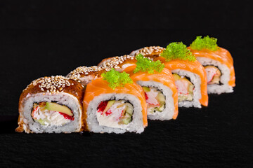 Roll with tobiko caviar, sesame seeds, salmon, eel, cucumber