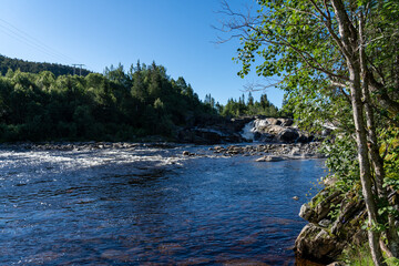 Naklejka na ściany i meble Waterfall of the river Steinsdalselva in Norway on a sunny day , salmon river Norway 