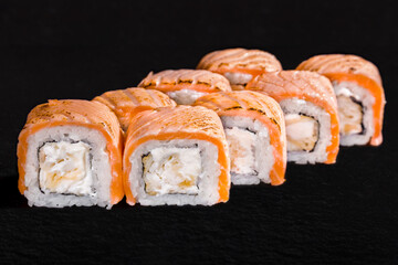 Roll with salmon, rice, nori, cream cheese and seafood