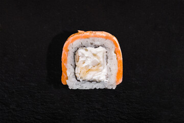 Roll with salmon, rice, nori, cream cheese and seafood