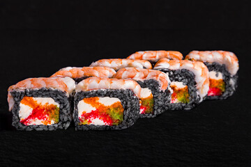Rolls with shrimp, black rice, tobiko caviar