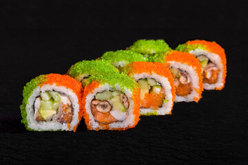 Rolls with nori, green and orange tobiko caviar, eel