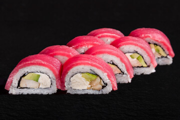 Rolls with tuna, rice, nori, eel and avocado