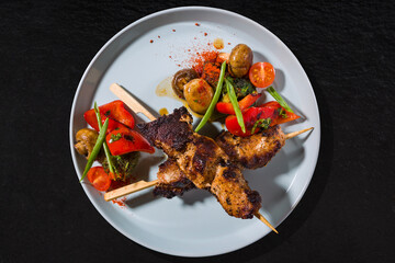 Shish kebab on a skewer with tomatoes, mushrooms, onions, paprika