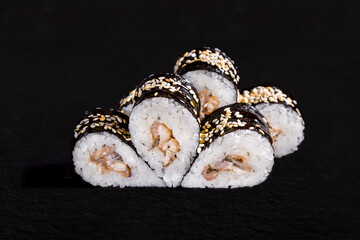 Rolls with rice, nori, sesame seeds, eel