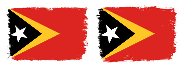 A set of two vector brush flags of Timor Leste with abstract shape brush stroke effect