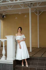 portrait of a young bride girl in a short white dress