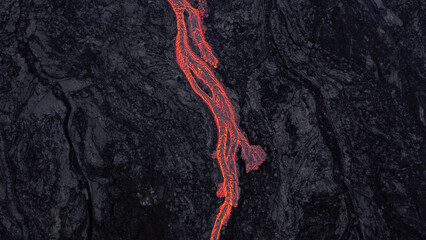 hot lava running on solidified black lava	
