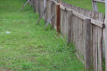Fototapeta na wymiar wooden fence on the green grass