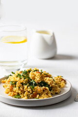 Salad made with bulgur, chopped parsley, tomatoes, mint, onion and seasoned with olive oil and lemon juice on the restaurant table.