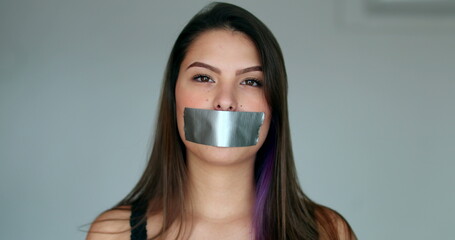 Woman mouth taped looking at camera