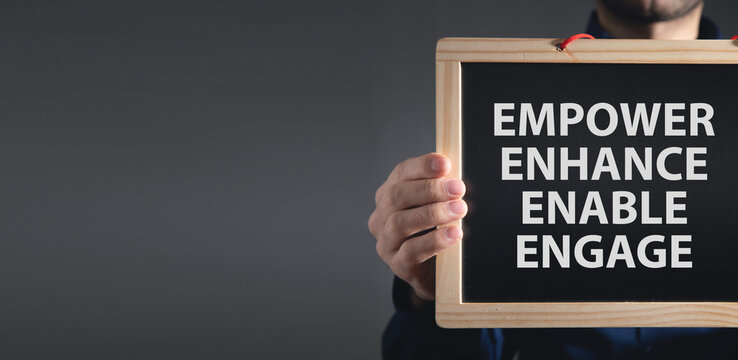 Man showing Empower Enhance Enable Engage concept.