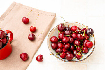 sweet cherry in a plate on a white background top view. cherry harvest. New 2023 trending PANTONE 18-1750 Viva Magenta color