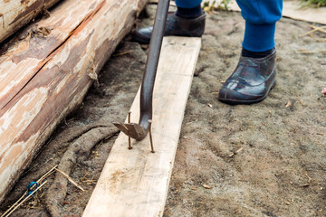 nail puller close-up, on the street. Pulling out old nails