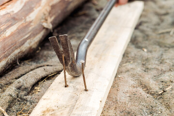 nail puller close-up, on the street. Pulling out old nails