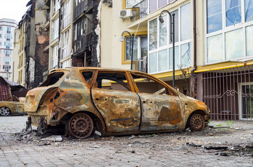 Atrocities of the russian army in the suburbs of Kyiv. Automobile and houses in of civilians...