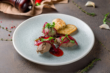 The chicken liver pate with bread and jam on plate on brown concrete table
