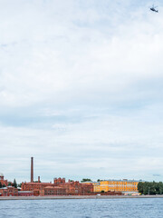 Fototapeta na wymiar Helicopter flying over the Neva River in St. Petersburg, Russia and Kresty prison, vertical photo
