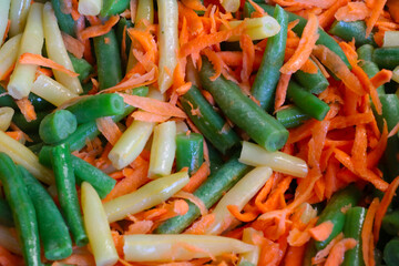 Asparagus beans with carrots cooked in a pan.
