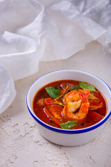 Soup with shrimps, tomatoes, sorrel, basil and nasturtia leaves