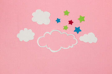 cloud as copy space, small clouds and colorful stars around the cloud, pink background, creative art modern design, abstract idea, clear air, pink sky
