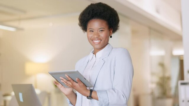Confident successful accountant scrolling the internet on a tablet in an office. Portrait of a happy African female financial advisor giving an online service to help clients. Business woman laughing