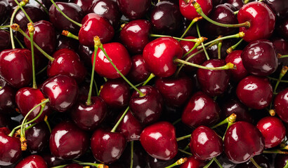 Fresh cherry on plate on pastel background. Top view, copy space