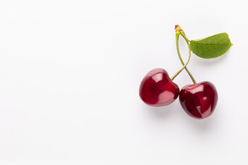 Cherry berries on a pastel background top view.  Background with a cherry on a sprig, flat lay