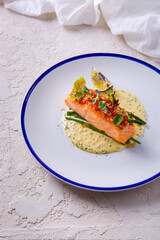 Grilled salmon steak with mung bean salad, lime, bell pepper, arugula, asparagus beans, cream sauce and mustard
