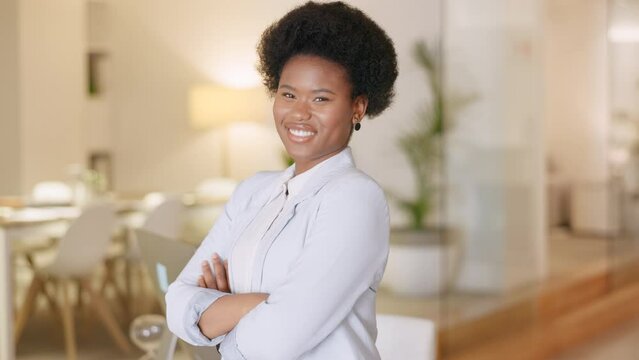 Portrait of a professional afro woman looking confident and empowered in her natural hair. One happy formal businesswoman with a big cheerful smile and crossed arms feeling confident in her workplace