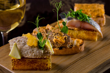 Assorted four bruschettas with a glass of white wine