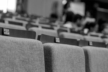 Blurred auditorium chairs with numbers, black and white