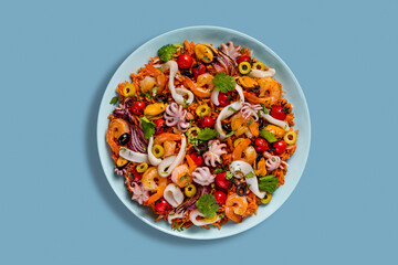 Salad with mussels, octopus, squid rings, cherries, shrimps, olives, rice, parsley and onions