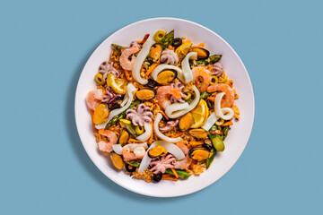 Salad with mussels, octopus, squid rings, lemon, shrimps, olives, rice, carrots and beans