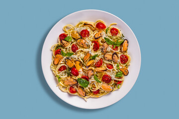 Spaghetti with mussels, cheese, tomatoes and basil