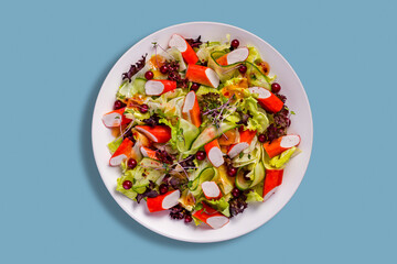Salad with crab sticks, cucumber, red currants, lettuce and sprouts