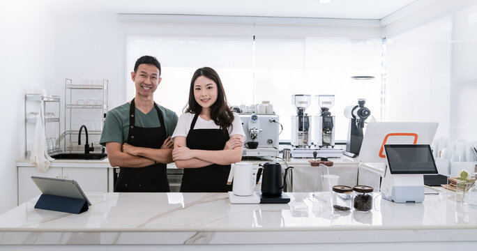Startup successful small business owner sme boy girl stand with tablet in coffee shop restaurant. Portrait of asian tan man woman barista cafe owner. SME entrepreneur seller business delivery concept