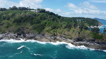 Obraz premium Promthep Cape is one of the most photographed locations in Phuket. Every evening, tour buses, scooters and private cars sweep through Rawai Beach and up the island's southernmost hill to watch the sun